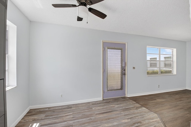 102 Normandy Ln Unit C, Delray Beach, FL 33484 - unfurnished room featuring wood finished floors, a ceiling fan, and a textured ceiling