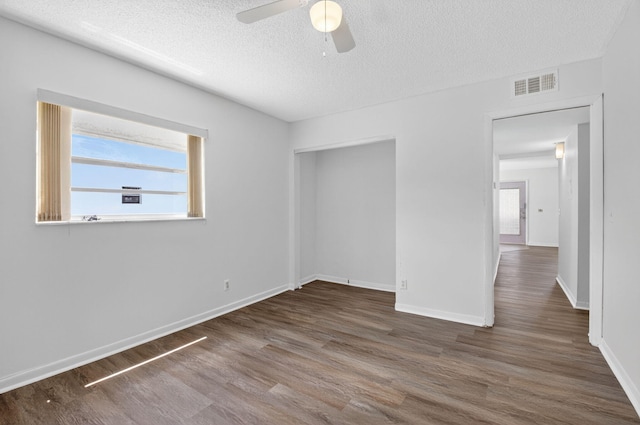 102 Normandy Ln Unit C, Delray Beach, FL 33484 - unfurnished bedroom with wood finished floors, a textured ceiling, ceiling fan, and a closet