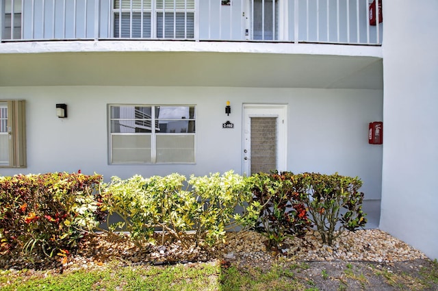 102 Normandy Ln Unit C, Delray Beach, FL 33484 - doorway to property featuring stucco siding