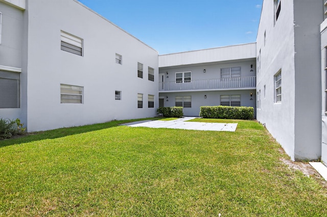 102 Normandy Ln Unit C, Delray Beach, FL 33484 - rear view of house with a yard and stucco siding