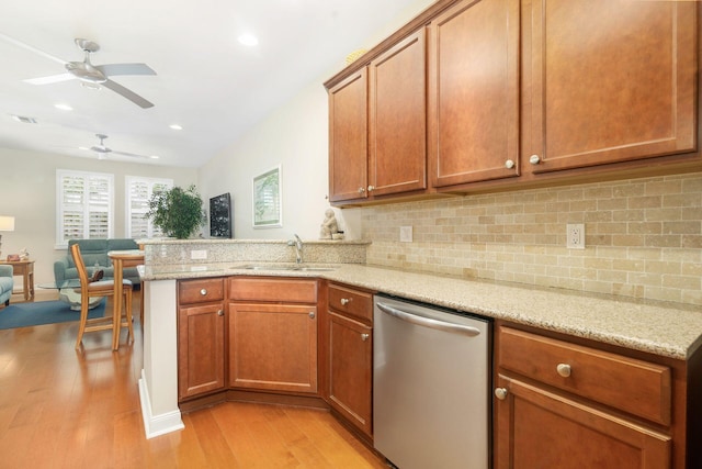 3330 W Mallory Blvd, Jupiter, FL 33458 - kitchen with dishwasher, light wood-style flooring, ceiling fan, a peninsula, and decorative backsplash