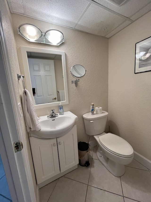 291 Saxony Unit G, Delray Beach, FL 33446 - bathroom with vanity, tile patterned flooring, a drop ceiling, and a textured wall