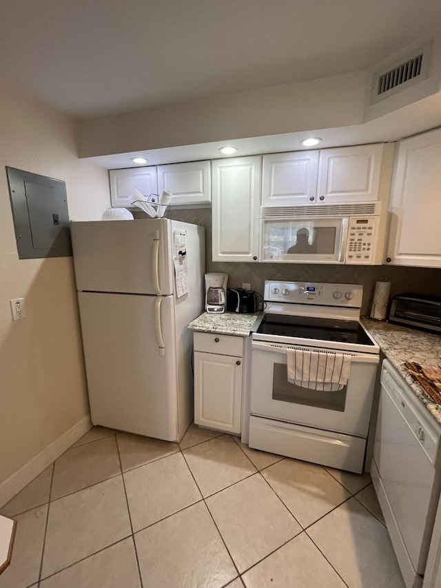 291 Saxony Unit G, Delray Beach, FL 33446 - kitchen featuring white appliances, electric panel, white cabinets, light tile patterned floors, and light stone countertops