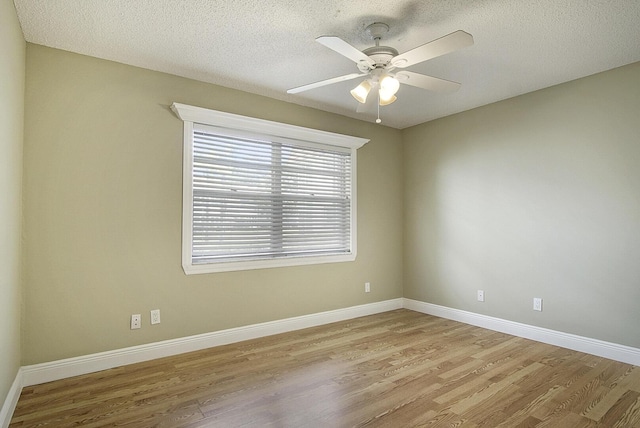 1225 NW 21st St Unit 3701, Stuart, FL 34994 - unfurnished room with light wood finished floors, a ceiling fan, and a textured ceiling