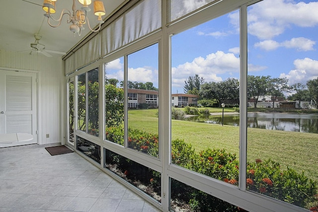 1225 NW 21st St Unit 3701, Stuart, FL 34994 - unfurnished sunroom with a water view, tile patterned floors, ceiling fan, and a chandelier