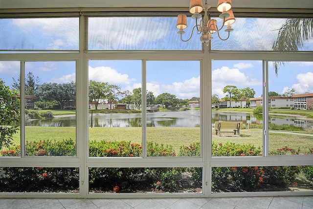 1225 NW 21st St Unit 3701, Stuart, FL 34994 - unfurnished sunroom featuring a water view, a chandelier, and plenty of natural light