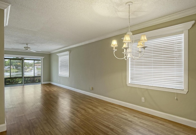 1225 NW 21st St Unit 3701, Stuart, FL 34994 - empty room with a textured ceiling, wood finished floors, a chandelier, ornamental molding, and a ceiling fan