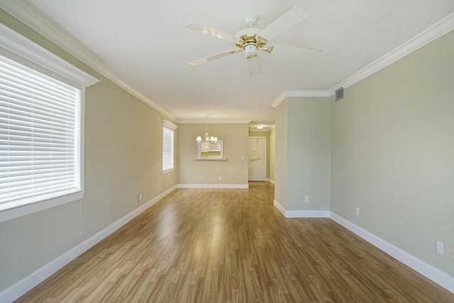 1225 NW 21st St Unit 3701, Stuart, FL 34994 - spare room with a chandelier, wood finished floors, ceiling fan, ornamental molding, and a textured ceiling