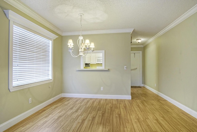 1225 NW 21st St Unit 3701, Stuart, FL 34994 - unfurnished dining area with wood finished floors, a chandelier, a textured ceiling, and ornamental molding