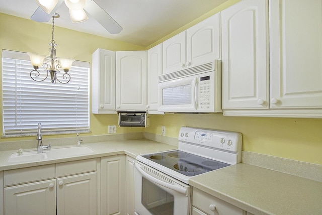 1225 NW 21st St Unit 3701, Stuart, FL 34994 - kitchen featuring white appliances, white cabinets, a chandelier, and light countertops