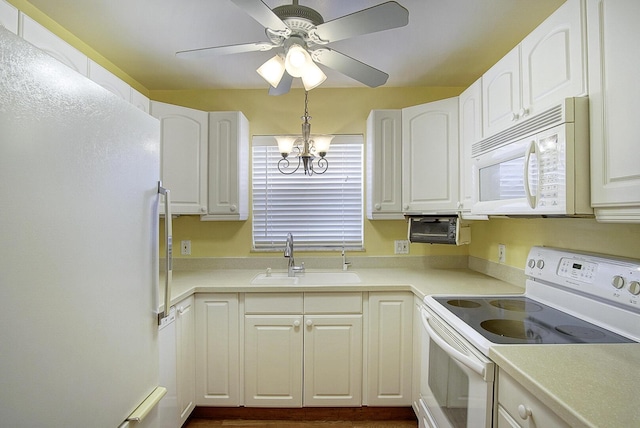1225 NW 21st St Unit 3701, Stuart, FL 34994 - kitchen with white appliances, white cabinets, ceiling fan, and light countertops