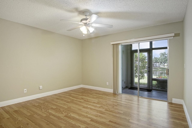 1225 NW 21st St Unit 3701, Stuart, FL 34994 - unfurnished room featuring light wood-style flooring, ceiling fan, and a textured ceiling