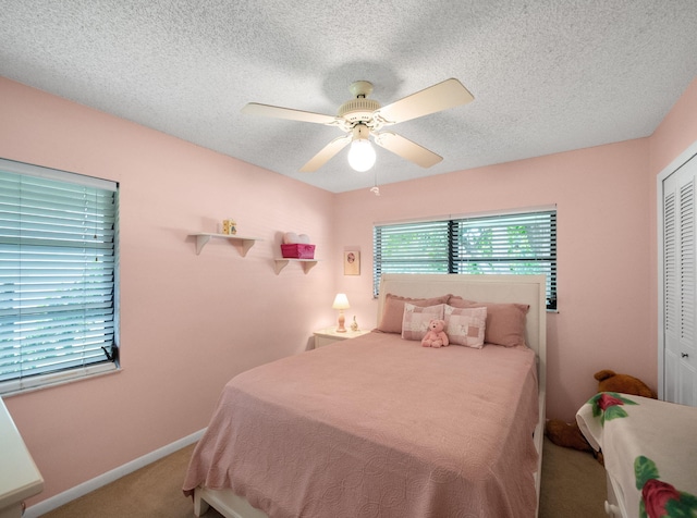 1680 SW Belgrave Ter, Stuart, FL 34997 - bedroom with carpet flooring, a closet, a textured ceiling, and a ceiling fan