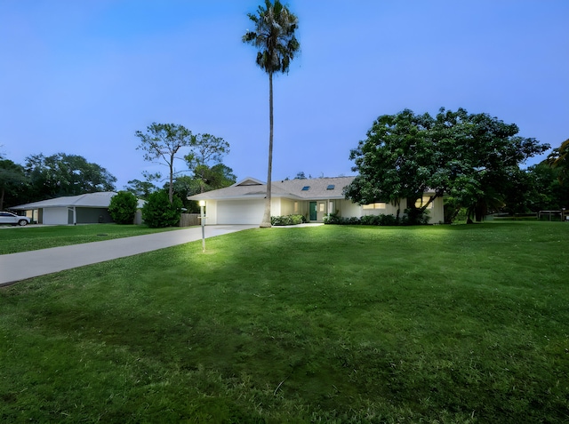 1680 SW Belgrave Ter, Stuart, FL 34997 - ranch-style home with concrete driveway, a garage, and a front lawn