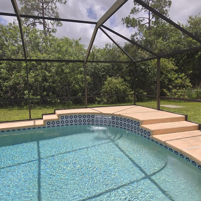 1680 SW Belgrave Ter, Stuart, FL 34997 - outdoor pool featuring glass enclosure