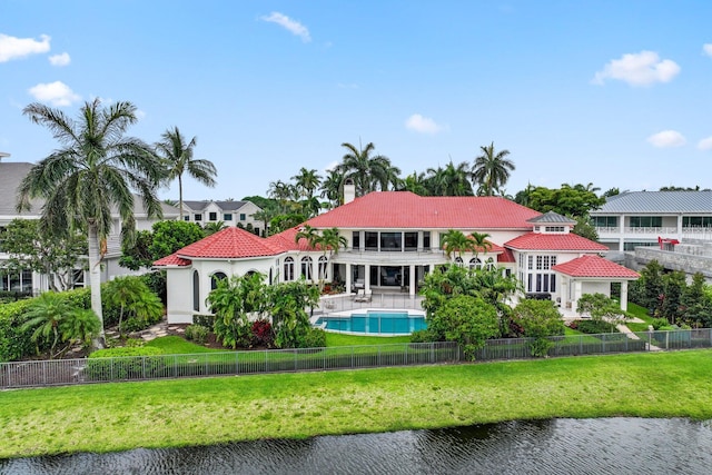 3643 Princeton Pl, Boca Raton, FL 33496 - back of house with a balcony, a chimney, a tiled roof, and a fenced backyard