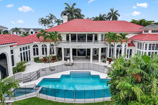 3643 Princeton Pl, Boca Raton, FL 33496 - rear view of property with a balcony, a tiled roof, a chimney, a patio, and stucco siding