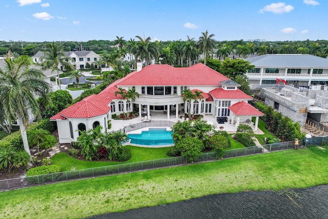 3643 Princeton Pl, Boca Raton, FL 33496 - back of house featuring a balcony, a tile roof, a fenced backyard, a patio area, and a chimney