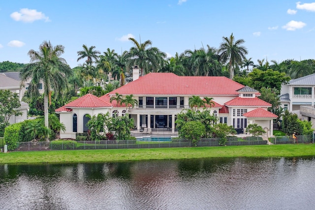 3643 Princeton Pl, Boca Raton, FL 33496 - back of property featuring a balcony, a chimney, a fenced backyard, and a water view