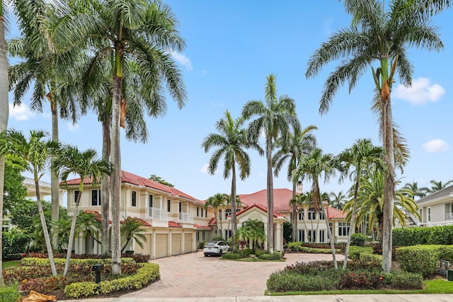 3643 Princeton Pl, Boca Raton, FL 33496 - view of front of house featuring decorative driveway, an attached garage, stucco siding, and a tile roof