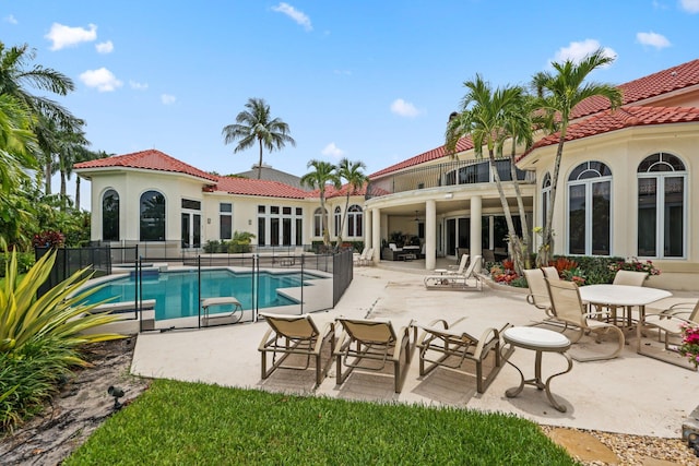 3643 Princeton Pl, Boca Raton, FL 33496 - back of house with a balcony, a tile roof, a patio, and stucco siding