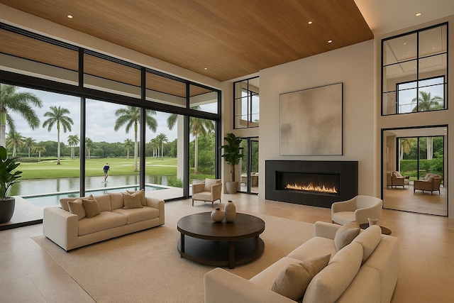 3643 Princeton Pl, Boca Raton, FL 33496 - tiled living room featuring a towering ceiling, wood ceiling, a glass covered fireplace, expansive windows, and a water view