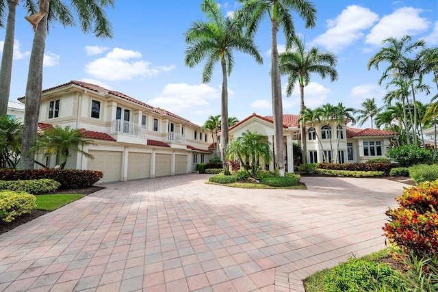 3643 Princeton Pl, Boca Raton, FL 33496 - mediterranean / spanish-style house featuring driveway, a garage, a balcony, stucco siding, and a tile roof