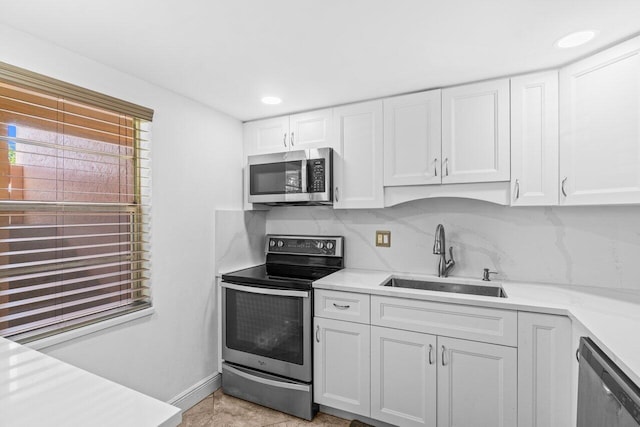 14721 Bonaire Blvd Unit 101, Delray Beach, FL 33446 - kitchen featuring appliances with stainless steel finishes, white cabinets, light countertops, recessed lighting, and decorative backsplash