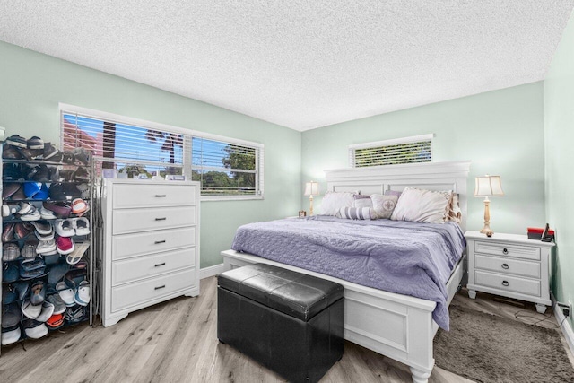 14721 Bonaire Blvd Unit 101, Delray Beach, FL 33446 - bedroom featuring wood finished floors and a textured ceiling