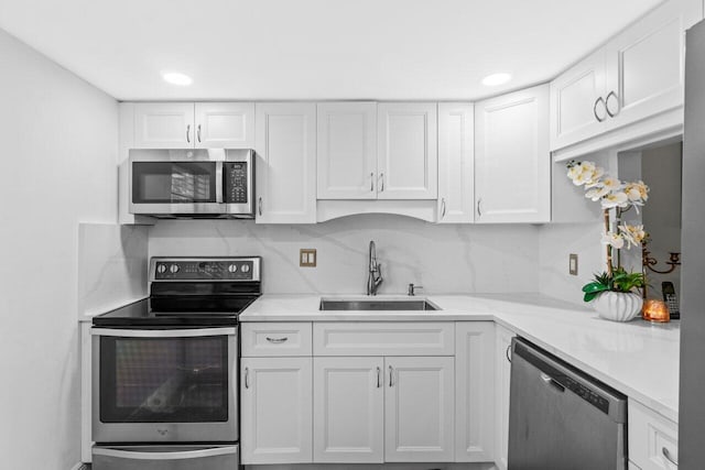 14721 Bonaire Blvd Unit 101, Delray Beach, FL 33446 - kitchen featuring appliances with stainless steel finishes, white cabinets, backsplash, and recessed lighting