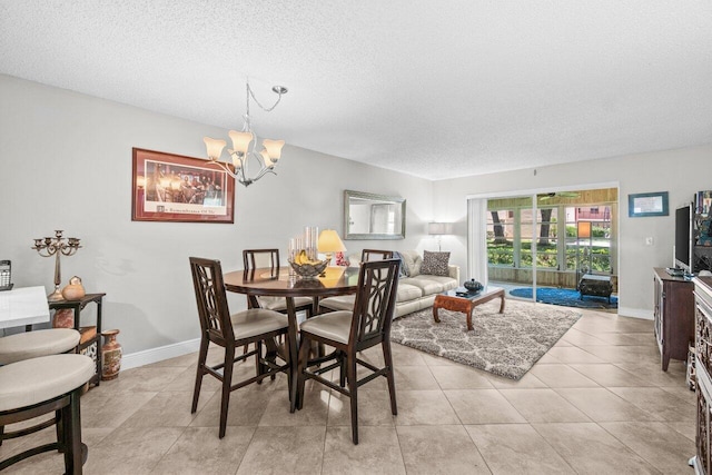 14721 Bonaire Blvd Unit 101, Delray Beach, FL 33446 - dining space with a textured ceiling and a chandelier