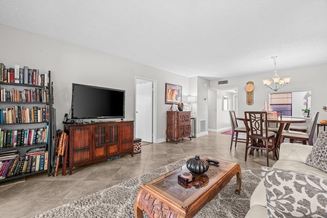 14721 Bonaire Blvd Unit 101, Delray Beach, FL 33446 - living room featuring a chandelier and a textured ceiling