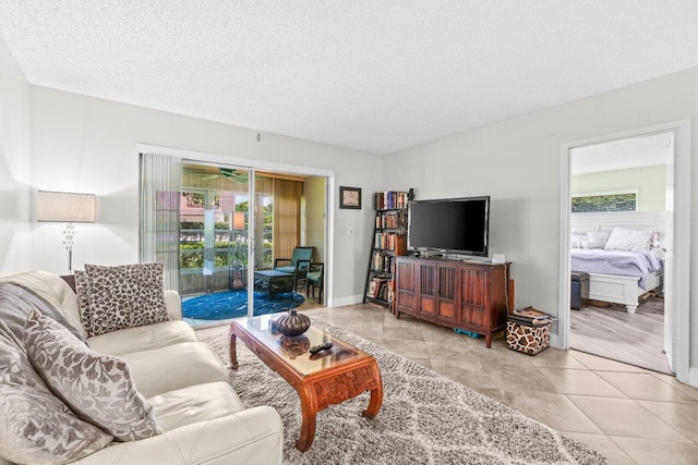 14721 Bonaire Blvd Unit 101, Delray Beach, FL 33446 - living area with healthy amount of natural light, a textured ceiling, and tile patterned flooring