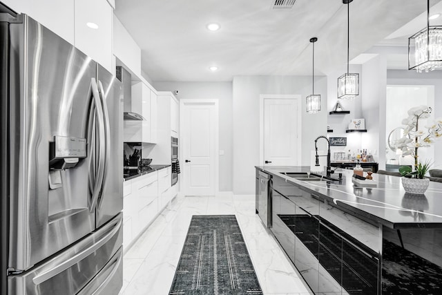 5476 NW Cambo Ct, Port Saint Lucie, FL 34986 - kitchen with appliances with stainless steel finishes, modern cabinets, white cabinetry, wall chimney range hood, and recessed lighting