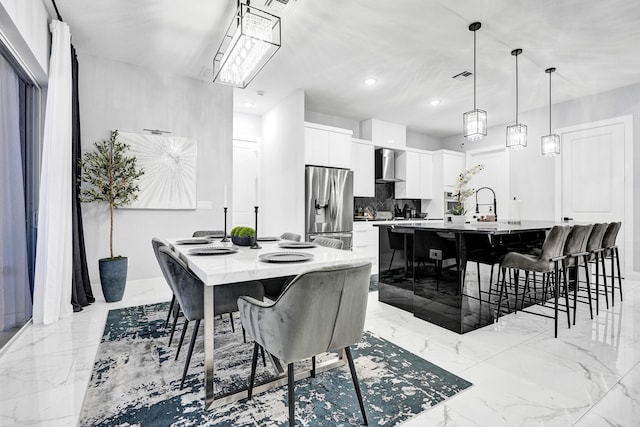 5476 NW Cambo Ct, Port Saint Lucie, FL 34986 - dining area featuring light marble finish floors and recessed lighting