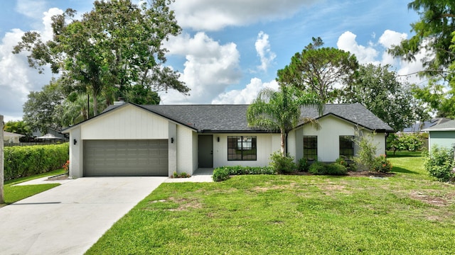 208 SW Langfield Ave, Port Saint Lucie, FL 34984 - view of front of property with an attached garage, concrete driveway, a front lawn, and roof with shingles