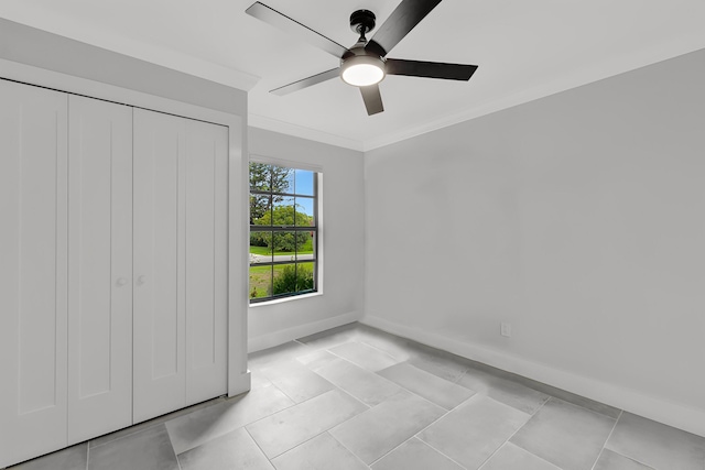 208 SW Langfield Ave, Port Saint Lucie, FL 34984 - unfurnished bedroom with crown molding, a closet, ceiling fan, and light tile patterned floors