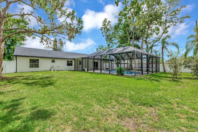 208 SW Langfield Ave, Port Saint Lucie, FL 34984 - back of property with a yard, glass enclosure, and stucco siding