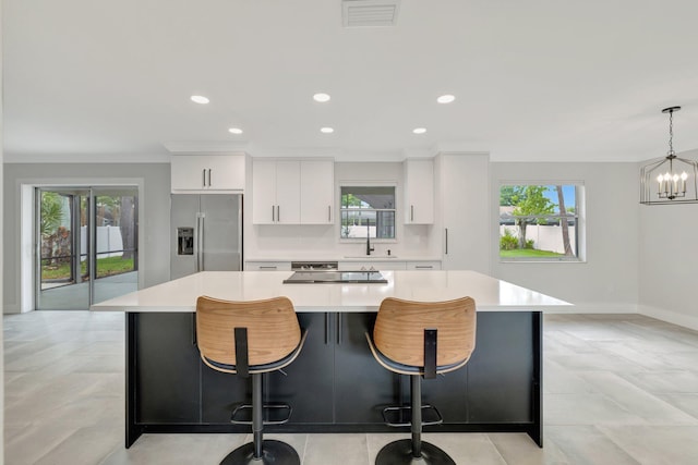 208 SW Langfield Ave, Port Saint Lucie, FL 34984 - kitchen with built in fridge, plenty of natural light, a kitchen island, light countertops, and recessed lighting
