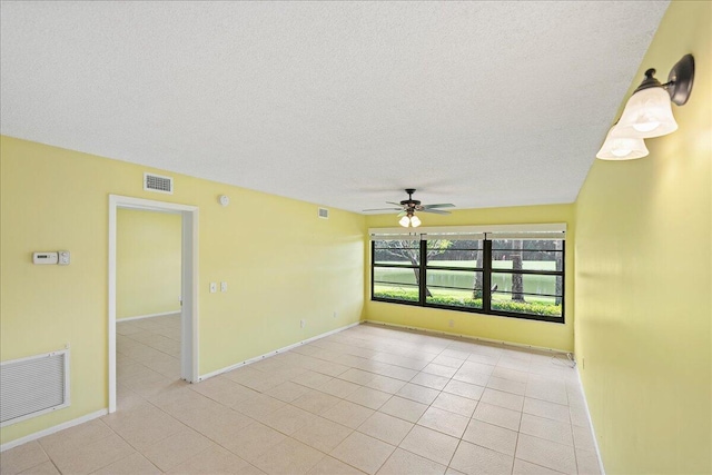 14 Plantation Dr Unit 105, Vero Beach, FL 32966 - spare room with a ceiling fan, a textured ceiling, and light tile patterned floors