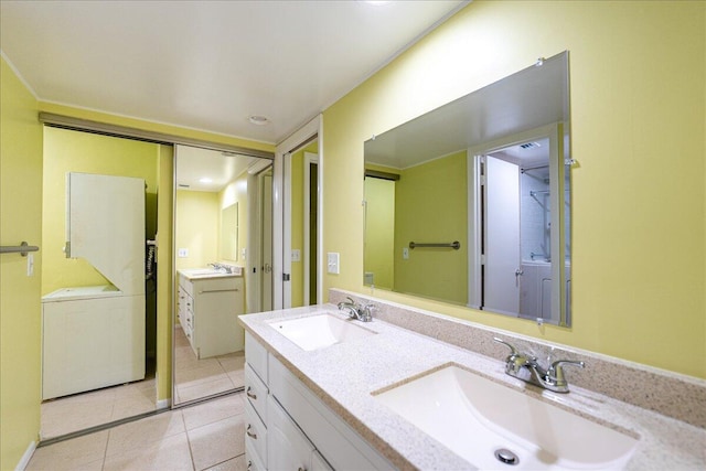 14 Plantation Dr Unit 105, Vero Beach, FL 32966 - full bathroom featuring tile patterned flooring, double vanity, and washer / dryer