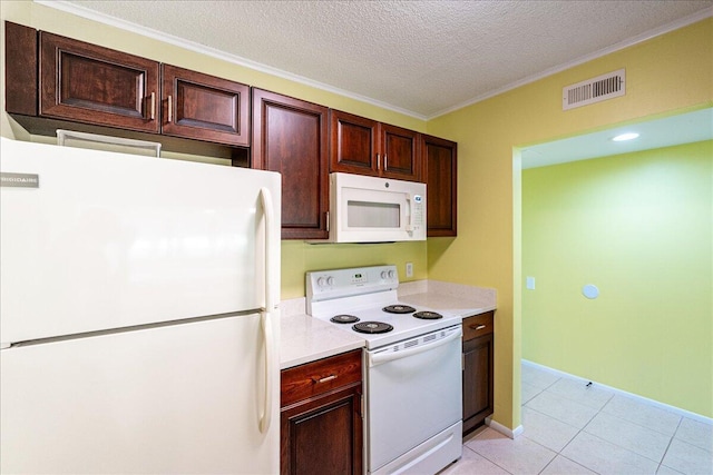 14 Plantation Dr Unit 105, Vero Beach, FL 32966 - kitchen with white appliances, light countertops, crown molding, light tile patterned floors, and a textured ceiling