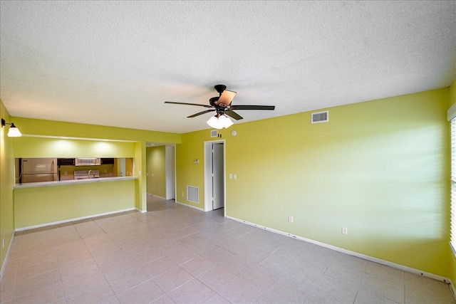 14 Plantation Dr Unit 105, Vero Beach, FL 32966 - unfurnished living room with a ceiling fan, a textured ceiling, and tile patterned floors