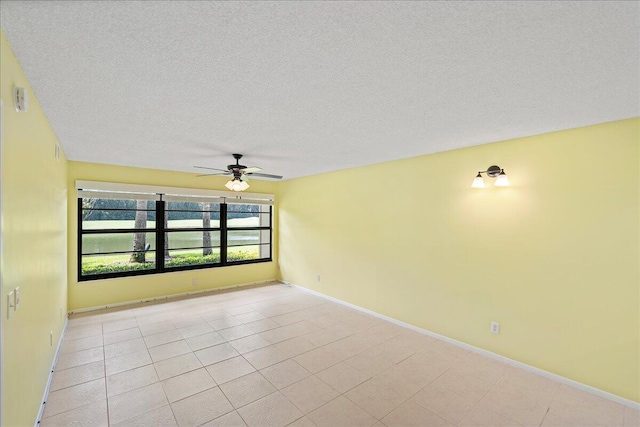 14 Plantation Dr Unit 105, Vero Beach, FL 32966 - empty room with a ceiling fan, a textured ceiling, and light tile patterned floors