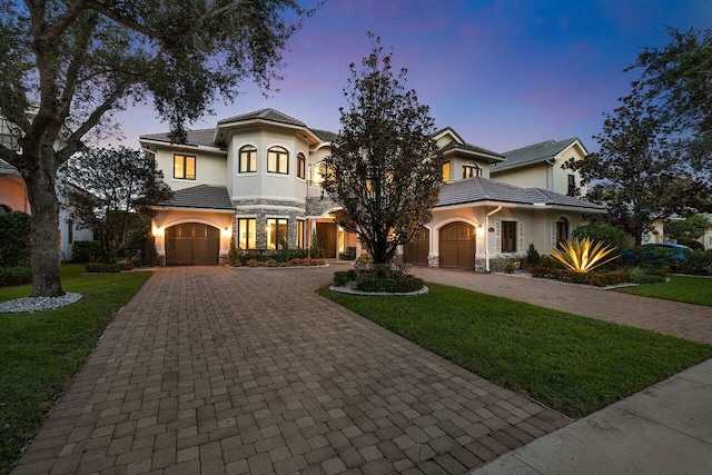 8984 Three Rail Dr, Boynton Beach, FL 33472 - mediterranean / spanish home featuring curved driveway, a yard, and stucco siding