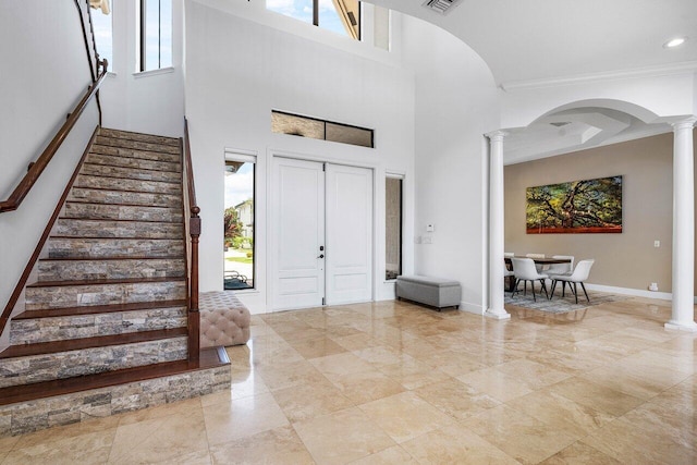 8984 Three Rail Dr, Boynton Beach, FL 33472 - foyer featuring ornate columns, stairway, healthy amount of natural light, ornamental molding, and a high ceiling