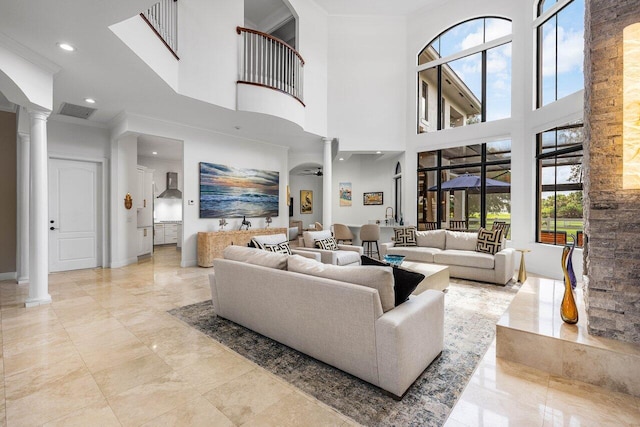 8984 Three Rail Dr, Boynton Beach, FL 33472 - living room featuring decorative columns, a towering ceiling, crown molding, and recessed lighting