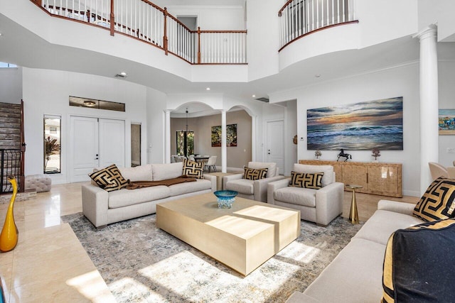 8984 Three Rail Dr, Boynton Beach, FL 33472 - living area featuring decorative columns, a high ceiling, arched walkways, and ornamental molding