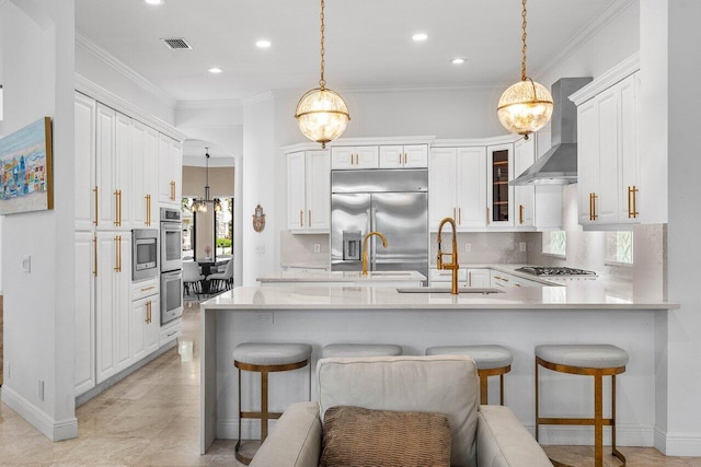 8984 Three Rail Dr, Boynton Beach, FL 33472 - kitchen featuring stainless steel appliances, wall chimney exhaust hood, a peninsula, a breakfast bar area, and recessed lighting