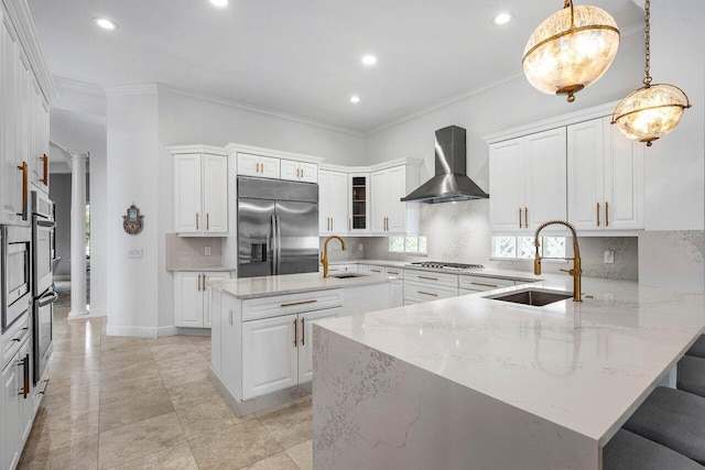 8984 Three Rail Dr, Boynton Beach, FL 33472 - kitchen featuring stainless steel appliances, wall chimney exhaust hood, ornate columns, a peninsula, and tasteful backsplash